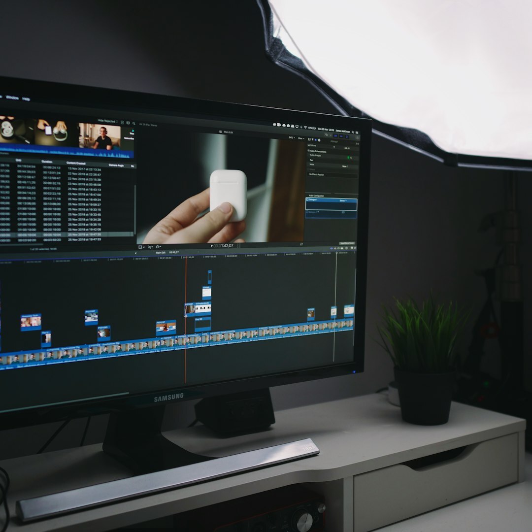 Professional Norwegian man video editor in his 40s with glasses at editing desk