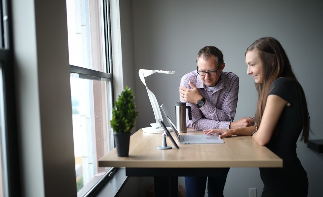 Diverse video production team collaborating around editing monitors in a modern office
